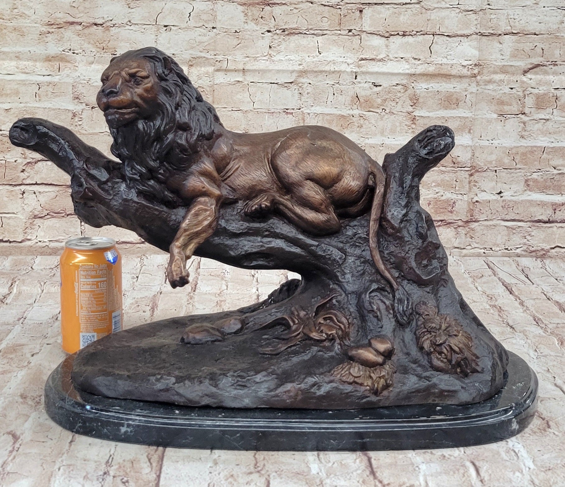 Lion Resting on a Branch - Bronze Sculpture by J. Moigniez