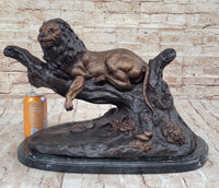 Lion Resting on a Branch - Bronze Sculpture by J. Moigniez