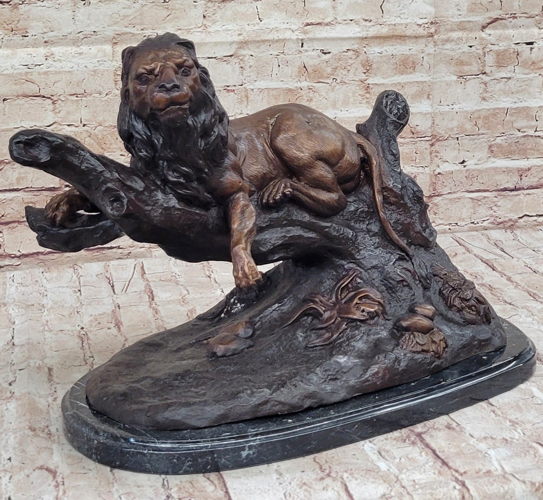 Lion Resting on a Branch - Bronze Sculpture by J. Moigniez