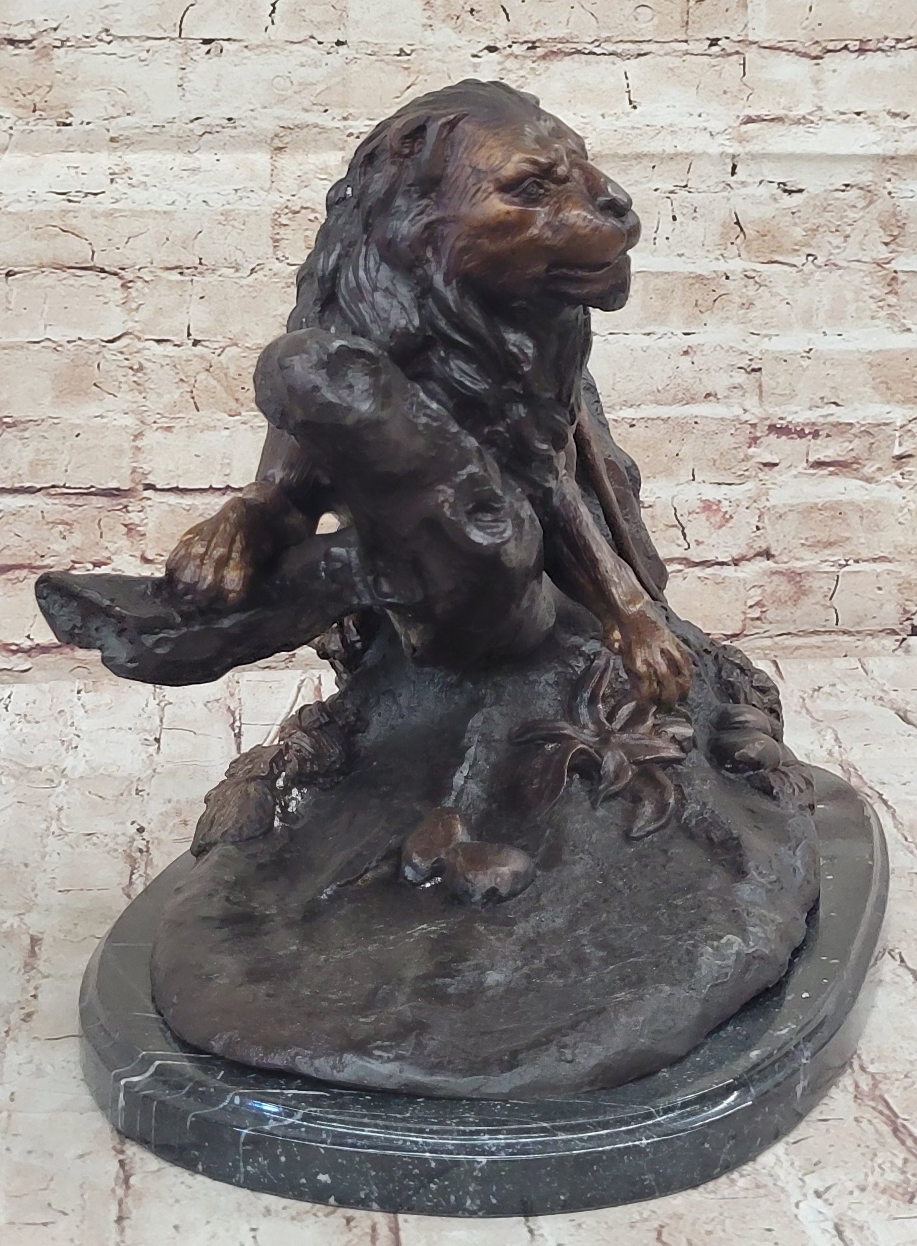 Lion Resting on a Branch - Bronze Sculpture by J. Moigniez