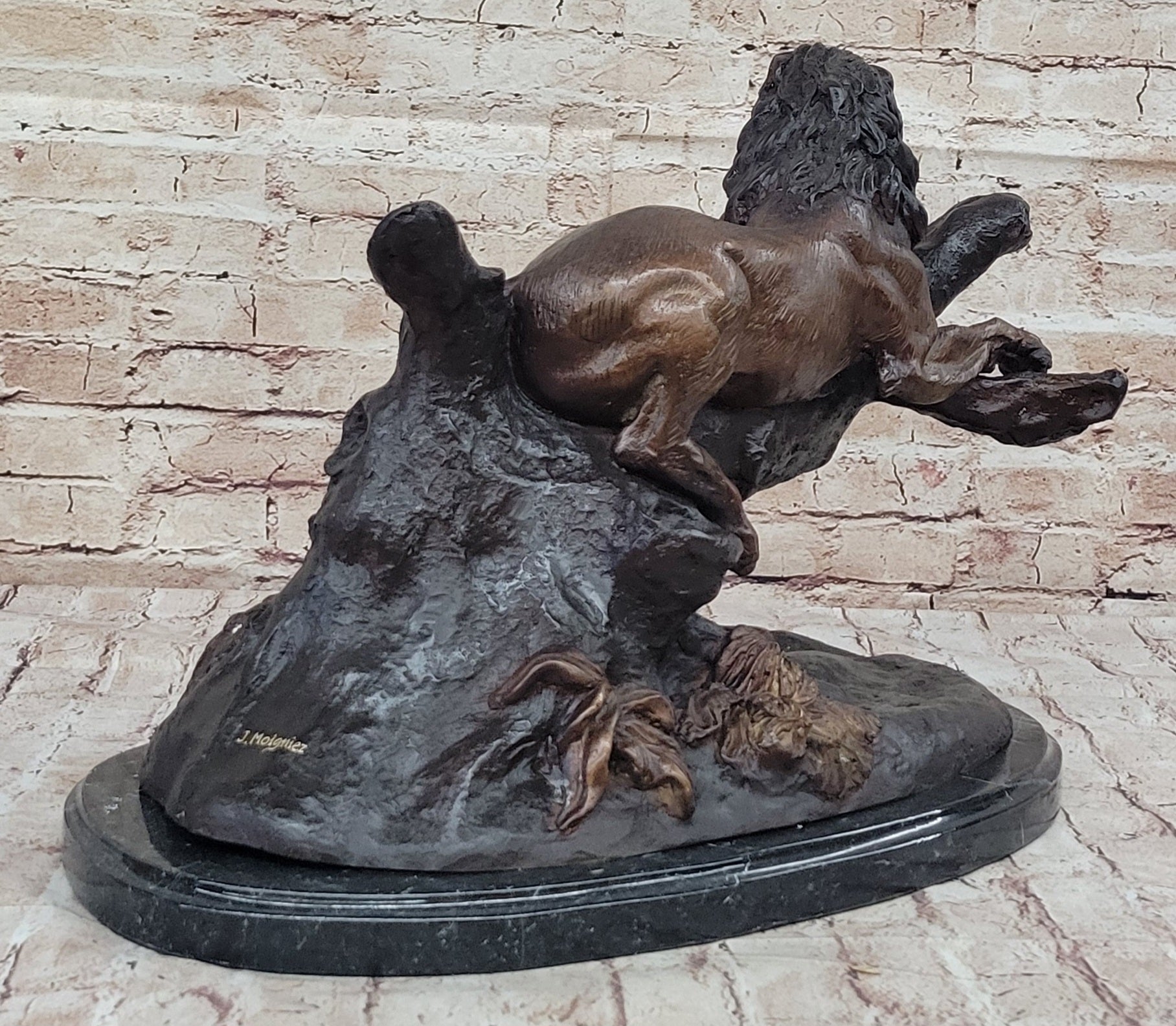 Lion Resting on a Branch - Bronze Sculpture by J. Moigniez