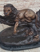 Lion Resting on a Branch - Bronze Sculpture by J. Moigniez
