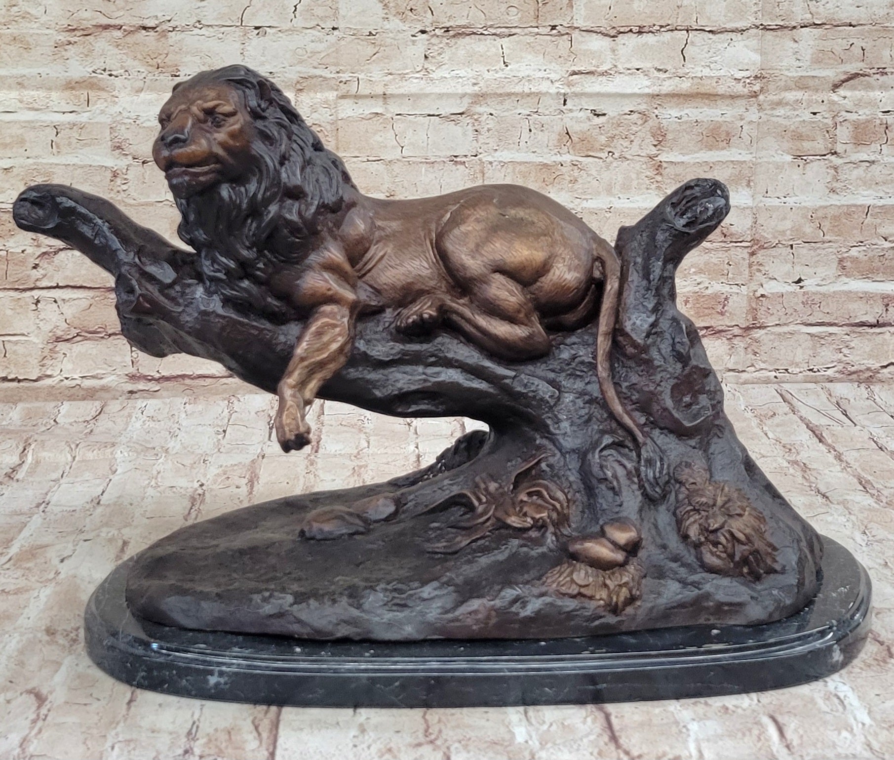 Lion Resting on a Branch - Bronze Sculpture by J. Moigniez
