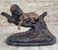 Lion Resting on a Branch - Bronze Sculpture by J. Moigniez