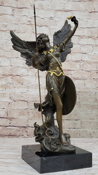 Bronze sculpture of Archangel Gabriel with a spear and shield, featuring gold accents on a marble base.
