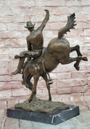 Bronze Sculpture Depicting a Cowboy on a Bucking Horse by Remington Art