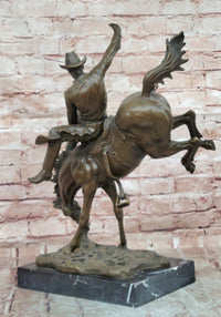 Bronze Sculpture Depicting a Cowboy on a Bucking Horse by Remington Art