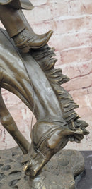 Bronze Sculpture Depicting a Cowboy on a Bucking Horse by Remington Art