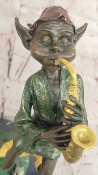 Bronze Elf Leprechaun Playing Golden Saxophone by Juno