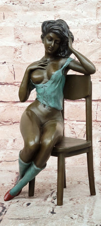 AN EROTIC BRONZE SCULPTURE OF A SEMI-NAKED WOMAN IN A CHAIR BY MILO STATUE