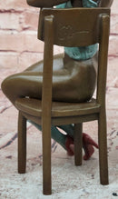 AN EROTIC BRONZE SCULPTURE OF A SEMI-NAKED WOMAN IN A CHAIR BY MILO STATUE