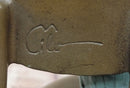 AN EROTIC BRONZE SCULPTURE OF A SEMI-NAKED WOMAN IN A CHAIR BY MILO STATUE