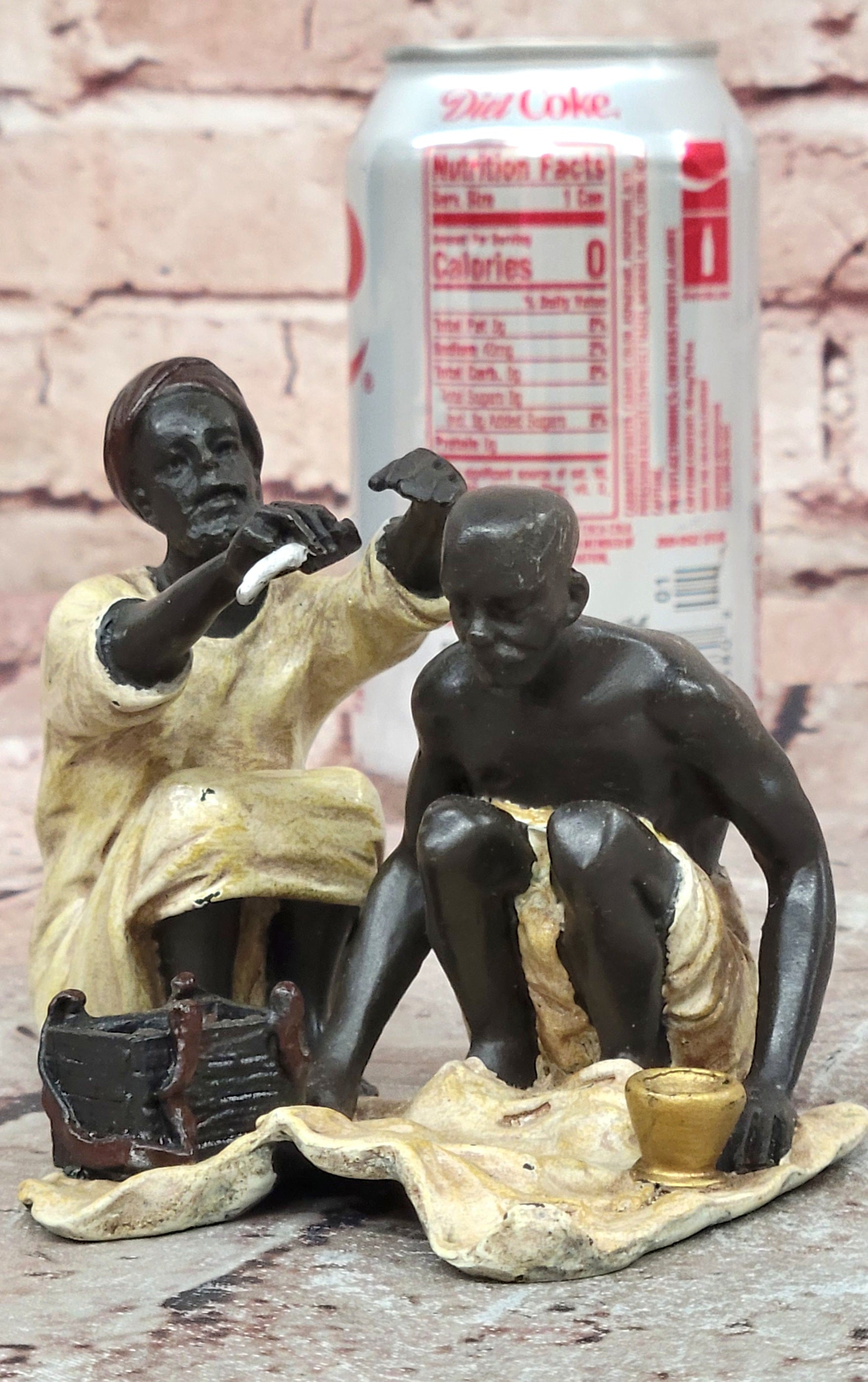 A Franz Bergman cold painted bronze figural group of an Arab barber at work