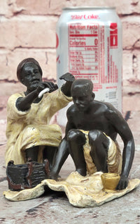 A Franz Bergman cold painted bronze figural group of an Arab barber at work