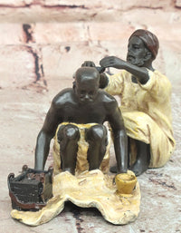 A Franz Bergman cold painted bronze figural group of an Arab barber at work