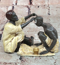 A Franz Bergman cold painted bronze figural group of an Arab barber at work