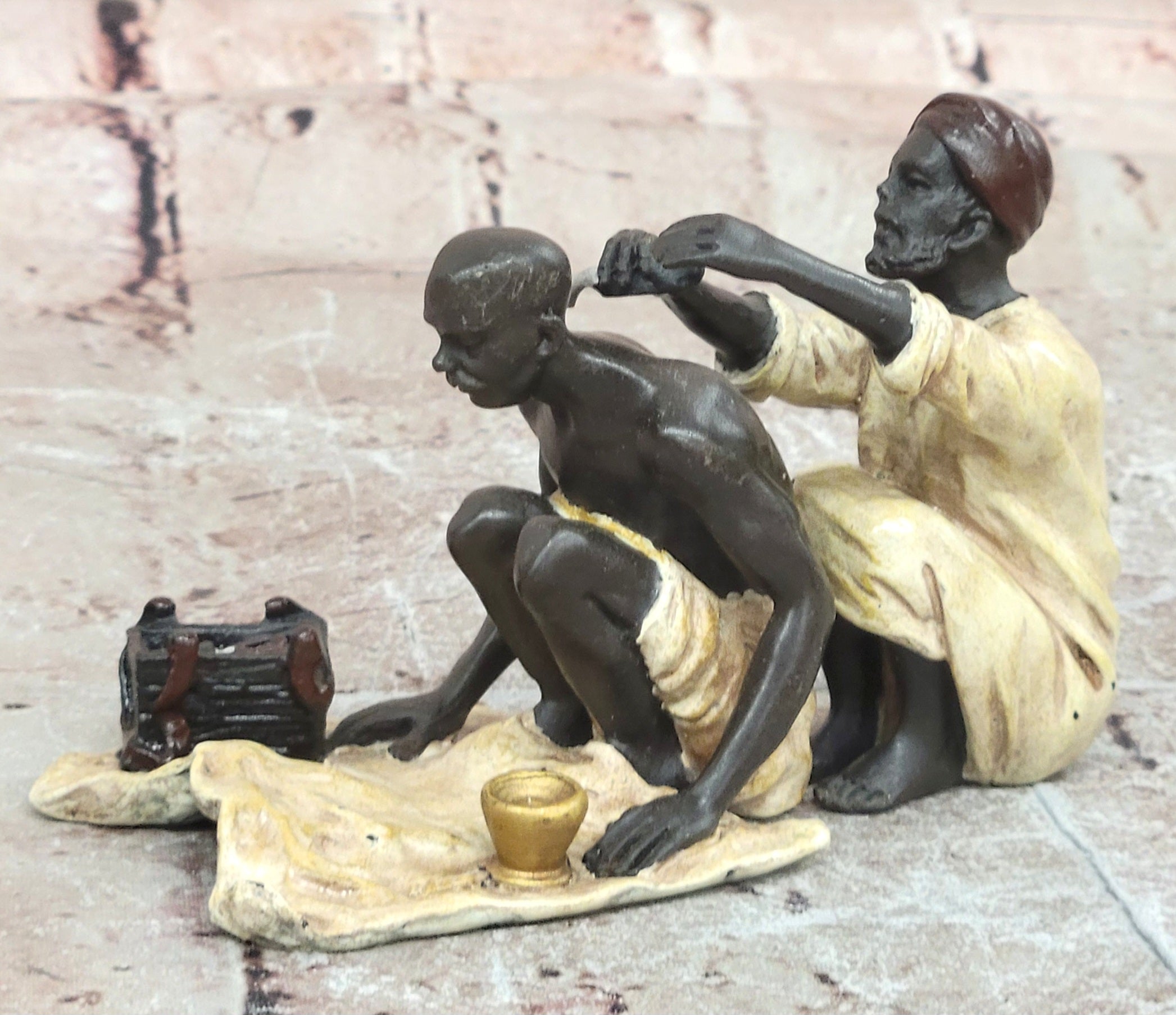 A Franz Bergman cold painted bronze figural group of an Arab barber at work