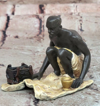 A Franz Bergman cold painted bronze figural group of an Arab barber at work