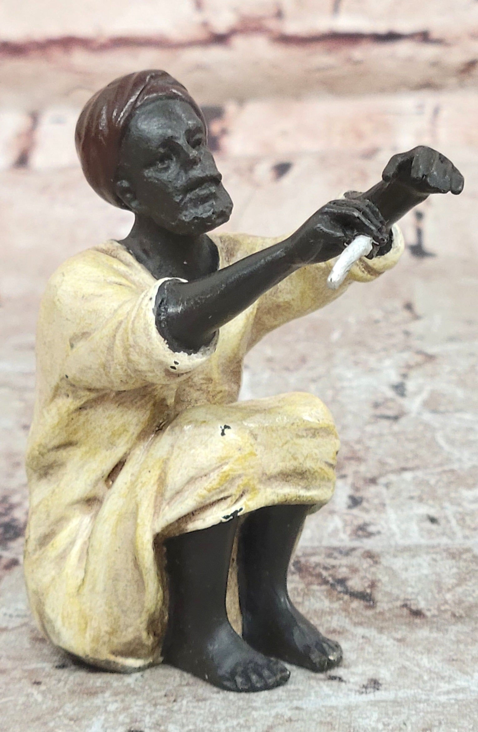 A Franz Bergman cold painted bronze figural group of an Arab barber at work