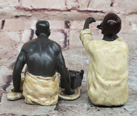 A Franz Bergman cold painted bronze figural group of an Arab barber at work