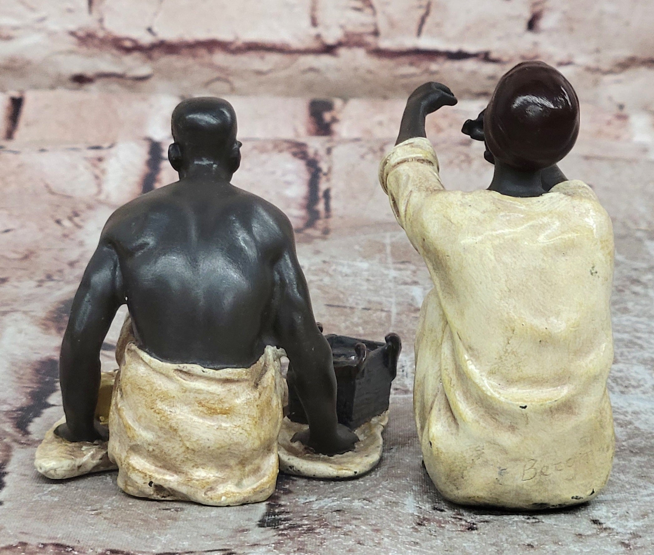 A Franz Bergman cold painted bronze figural group of an Arab barber at work