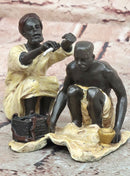 A Franz Bergman cold painted bronze figural group of an Arab barber at work