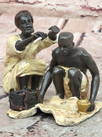 A Franz Bergman cold painted bronze figural group of an Arab barber at work