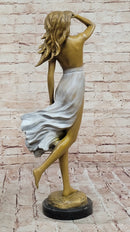 Graceful Bronze Woman in Flowing Dress – Wind Blown