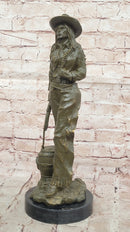 Western Bronze Cowgirl Sculpture with Rifle and Cowboy Hat