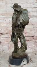 Cowboy with Saddle Bronze Sculpture - Western Art