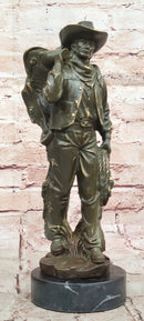 Cowboy with Saddle Bronze Sculpture - Western Art