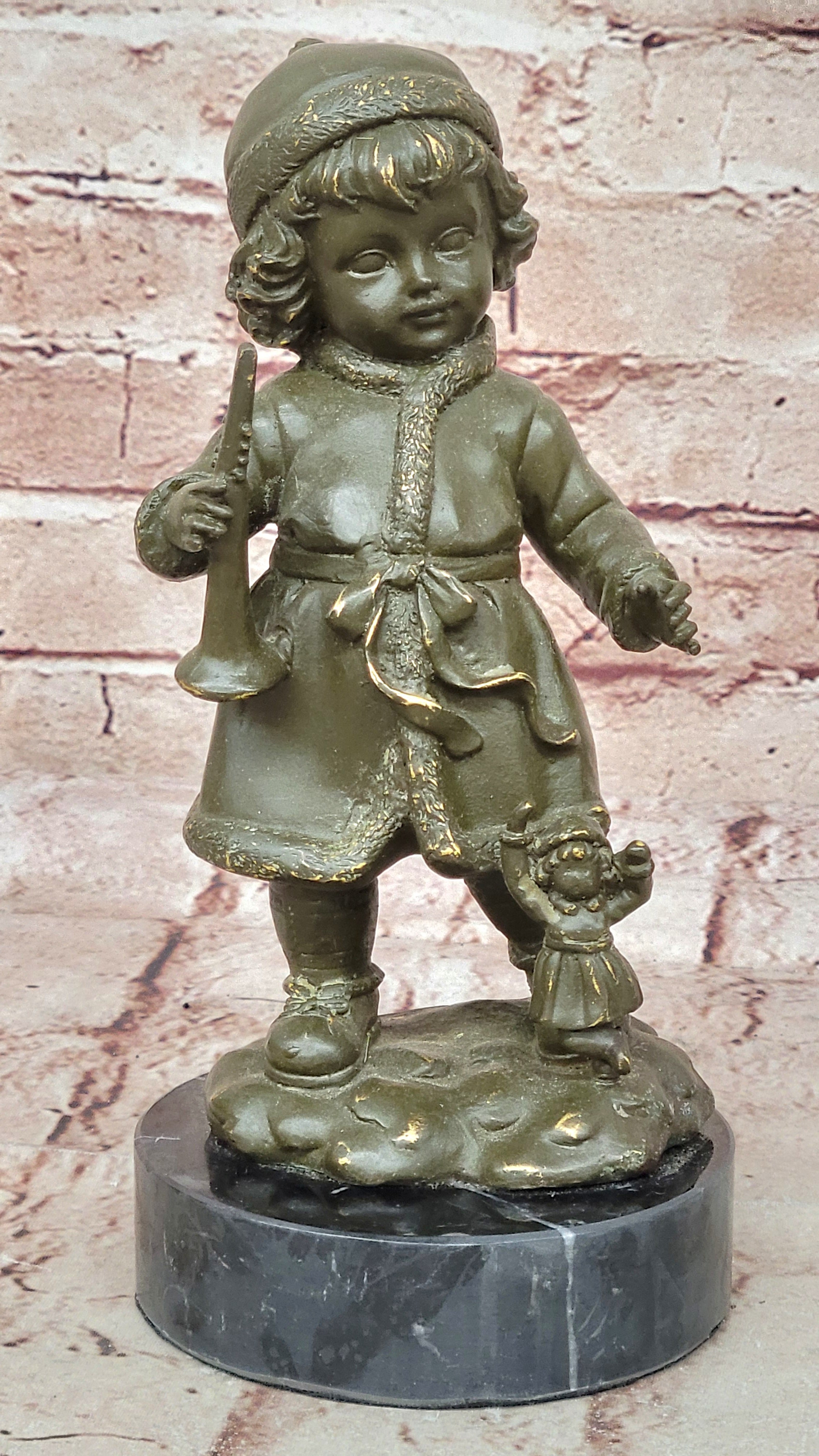 Bronze Winter Child Sculpture – Girl with Horn and Doll