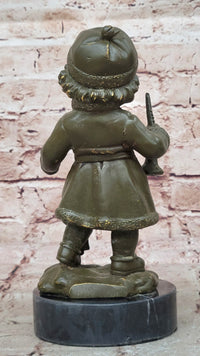 Bronze Winter Child Sculpture – Girl with Horn and Doll