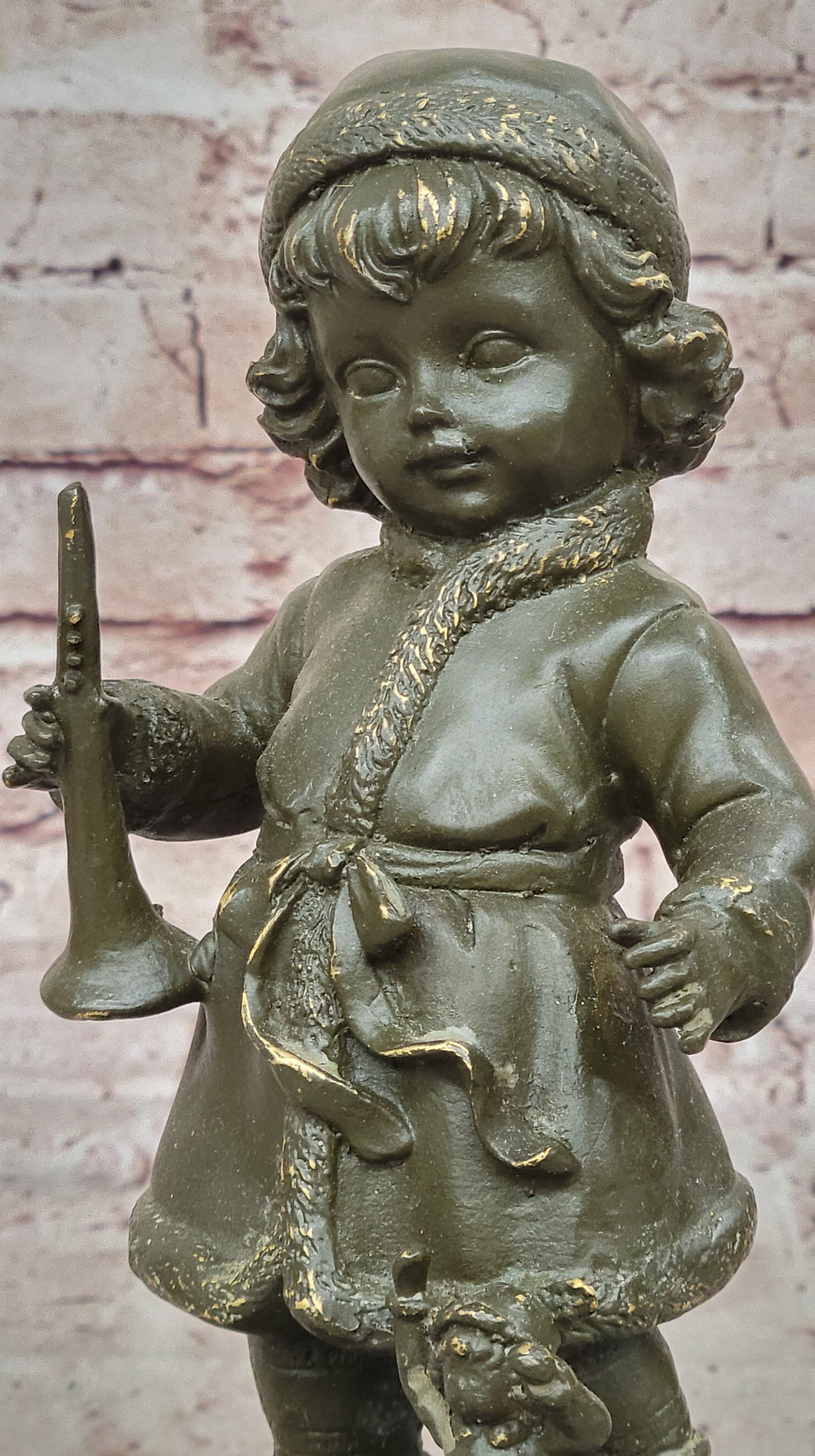Bronze Winter Child Sculpture – Girl with Horn and Doll