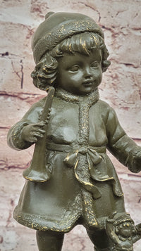 Bronze Winter Child Sculpture – Girl with Horn and Doll