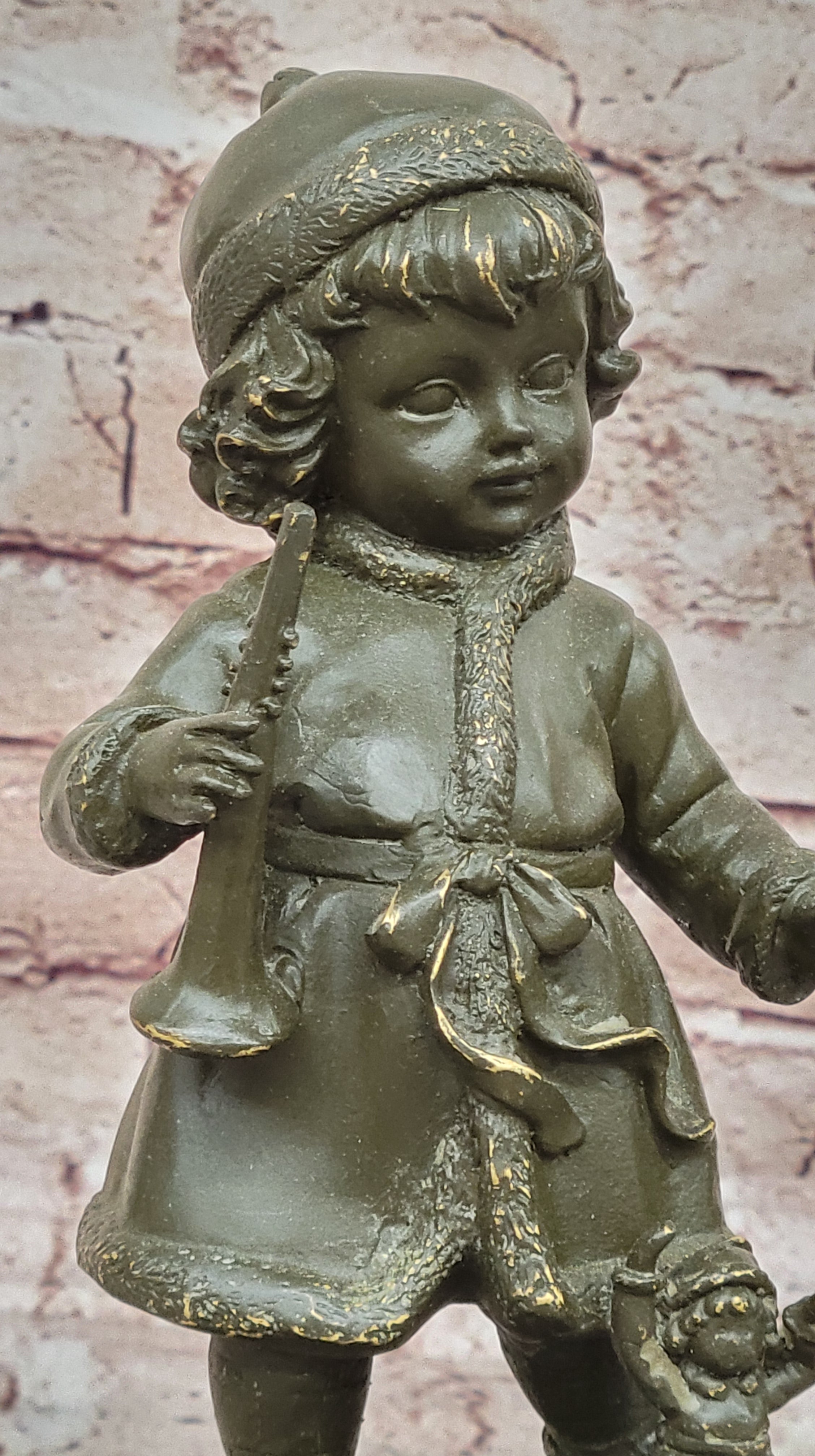 Bronze Winter Child Sculpture – Girl with Horn and Doll