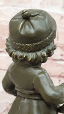 Bronze Winter Child Sculpture – Girl with Horn and Doll