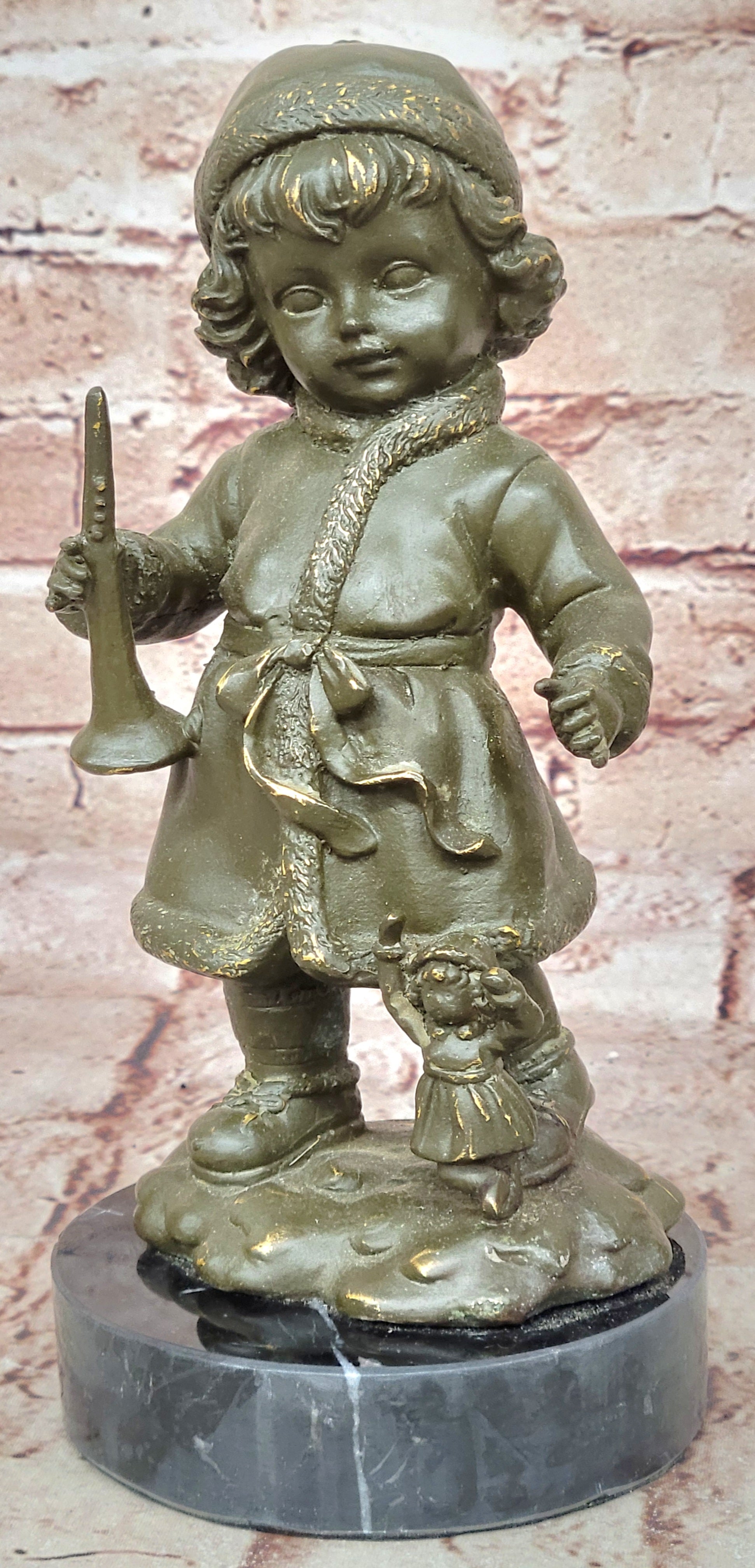 Bronze Winter Child Sculpture – Girl with Horn and Doll