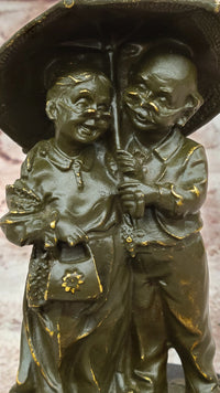 Bronze Elderly Couple Sculpture – Holding Umbrella