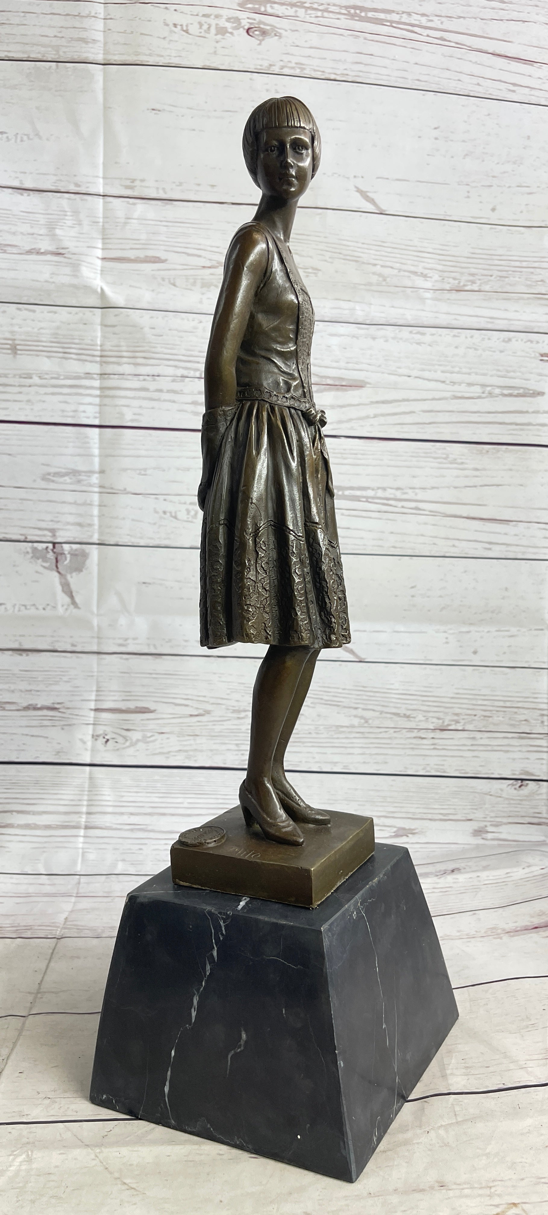 Young Woman in Dress With Short Hair Bronze Sculpture on Marble