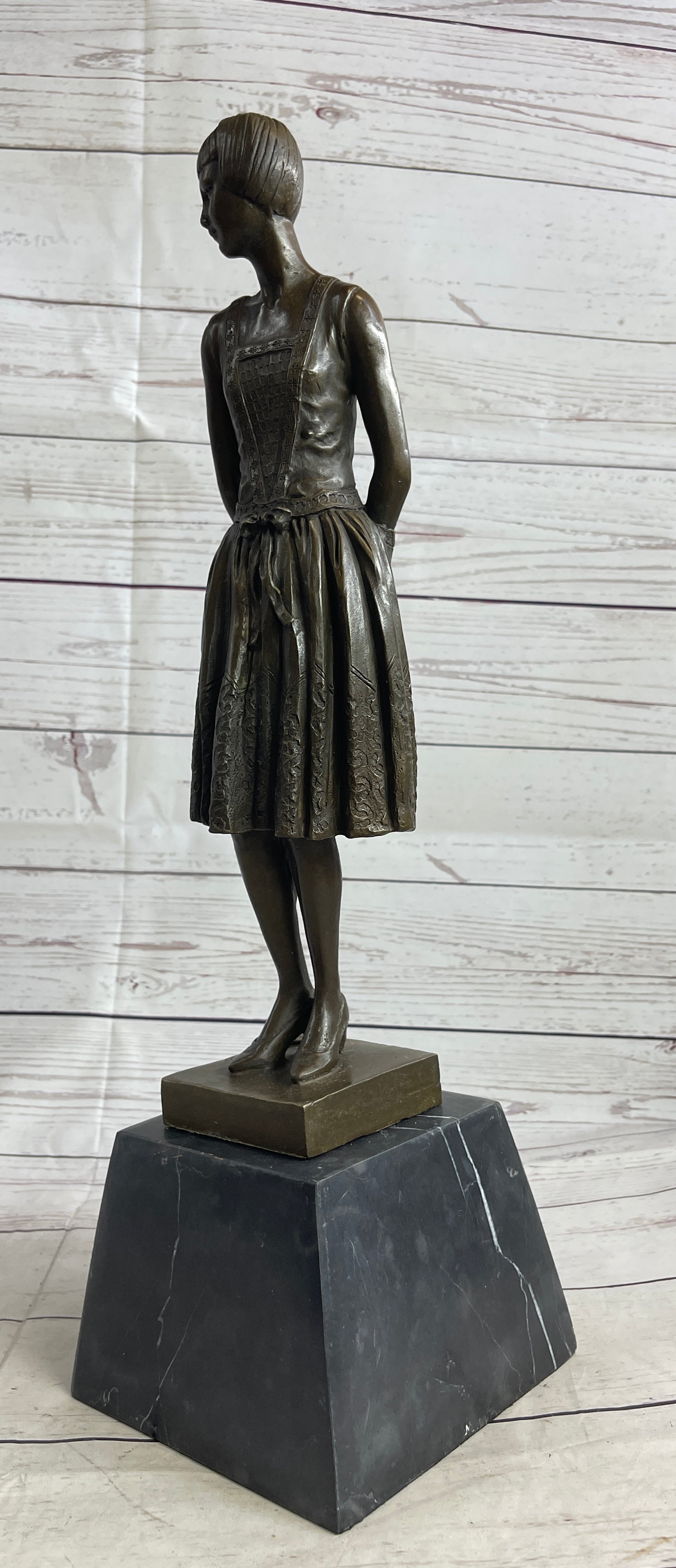 Young Woman in Dress With Short Hair Bronze Sculpture on Marble
