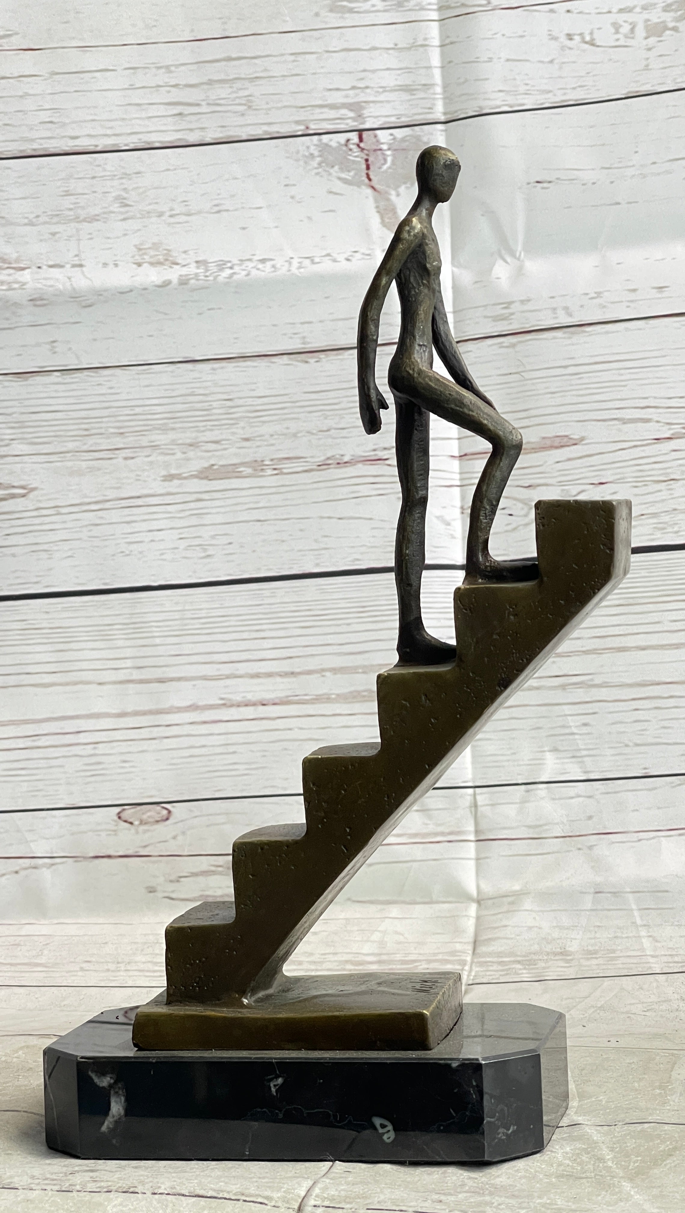 Abstract Bronze Sculpture of Man Climbing Stairs by Mario Nick