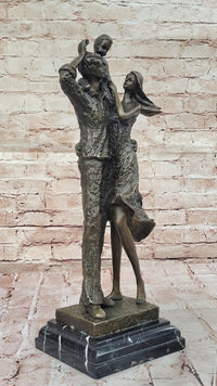 Bronze Family Sculpture – Joyful Moments with Parents and Child