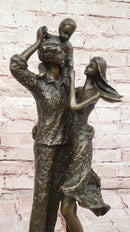 Bronze Family Sculpture – Joyful Moments with Parents and Child