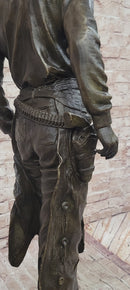 Cowboy Holding Horse Saddle - Western Art Bronze Sculpture