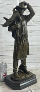 Country Western Cowboy Hauling Saddle Bronze Sculpture