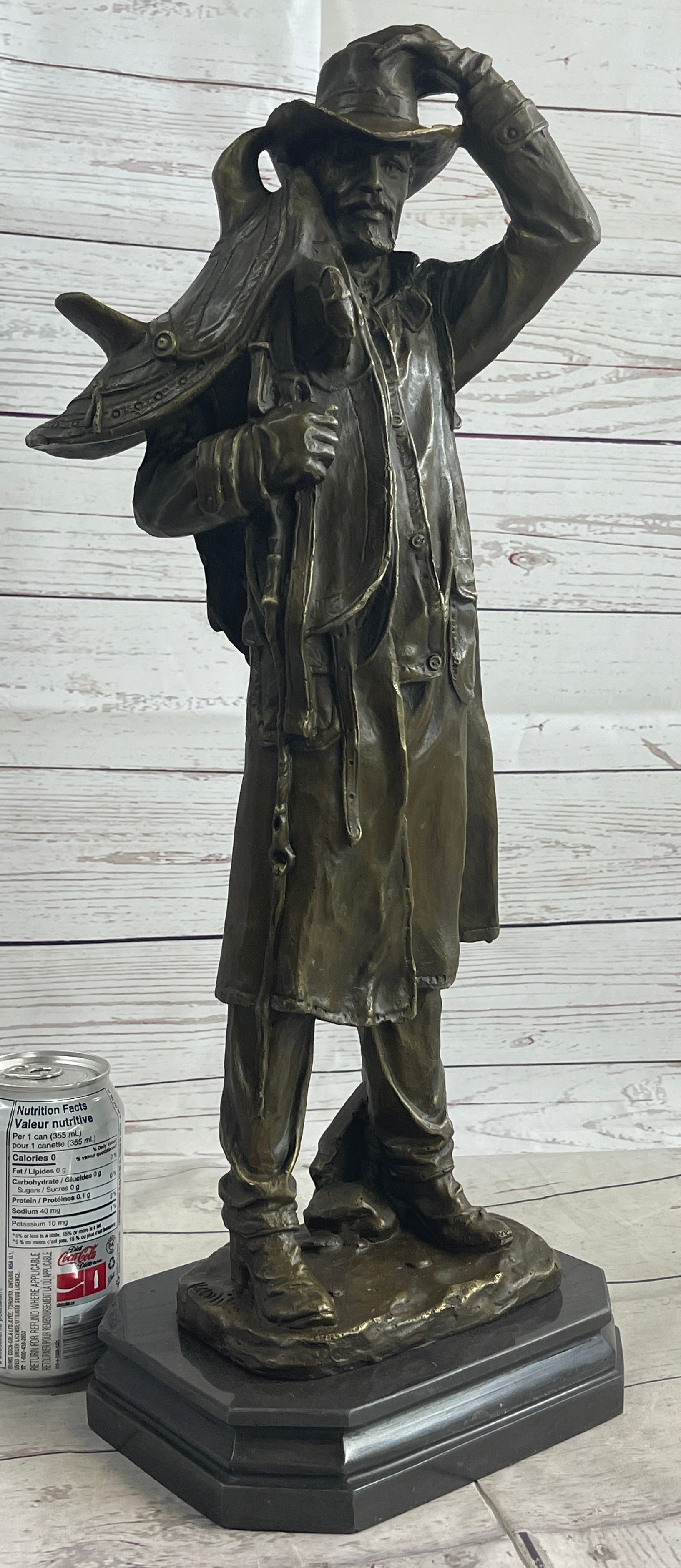 Country Western Cowboy Hauling Saddle Bronze Sculpture