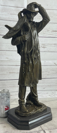 Country Western Cowboy Hauling Saddle Bronze Sculpture