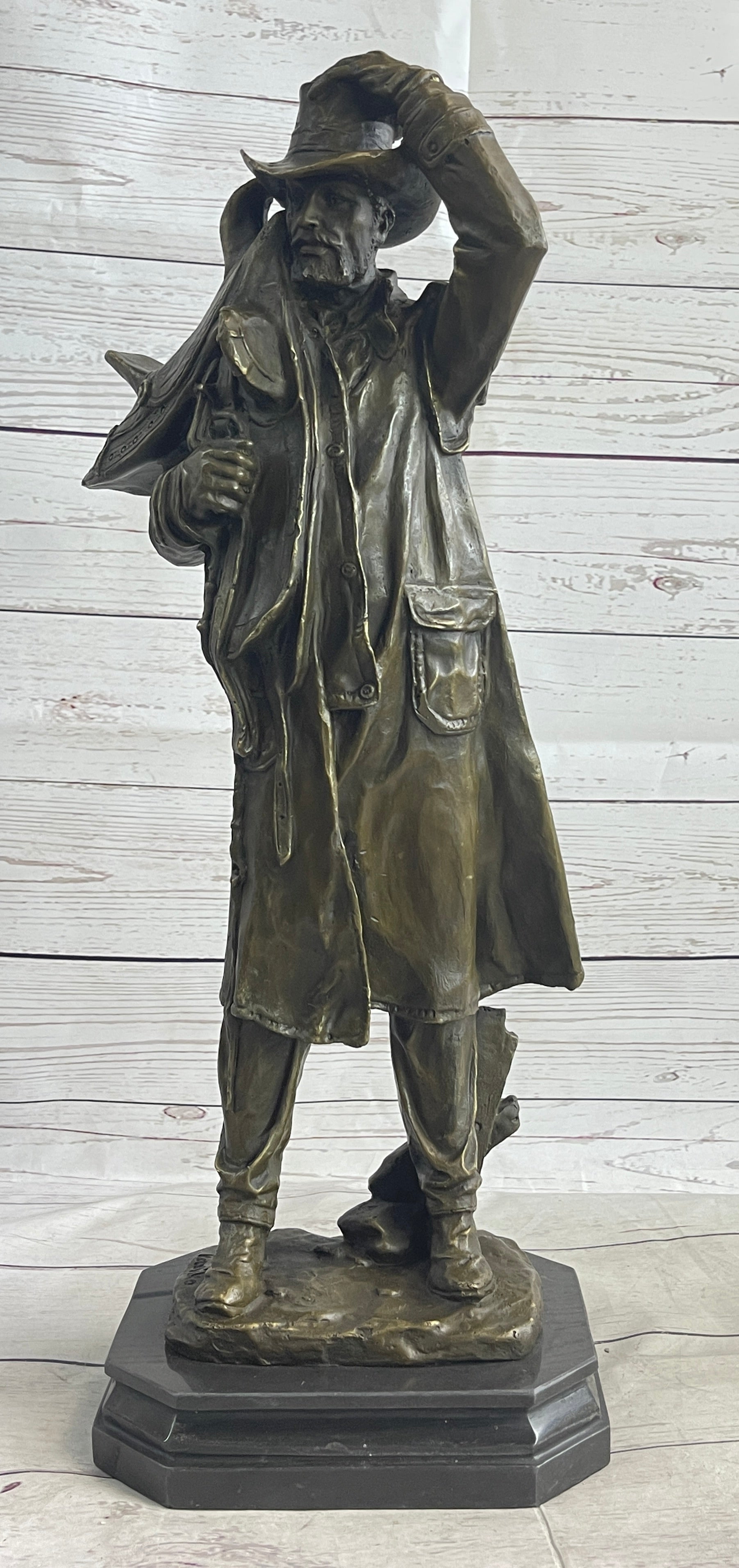 Country Western Cowboy Hauling Saddle Bronze Sculpture