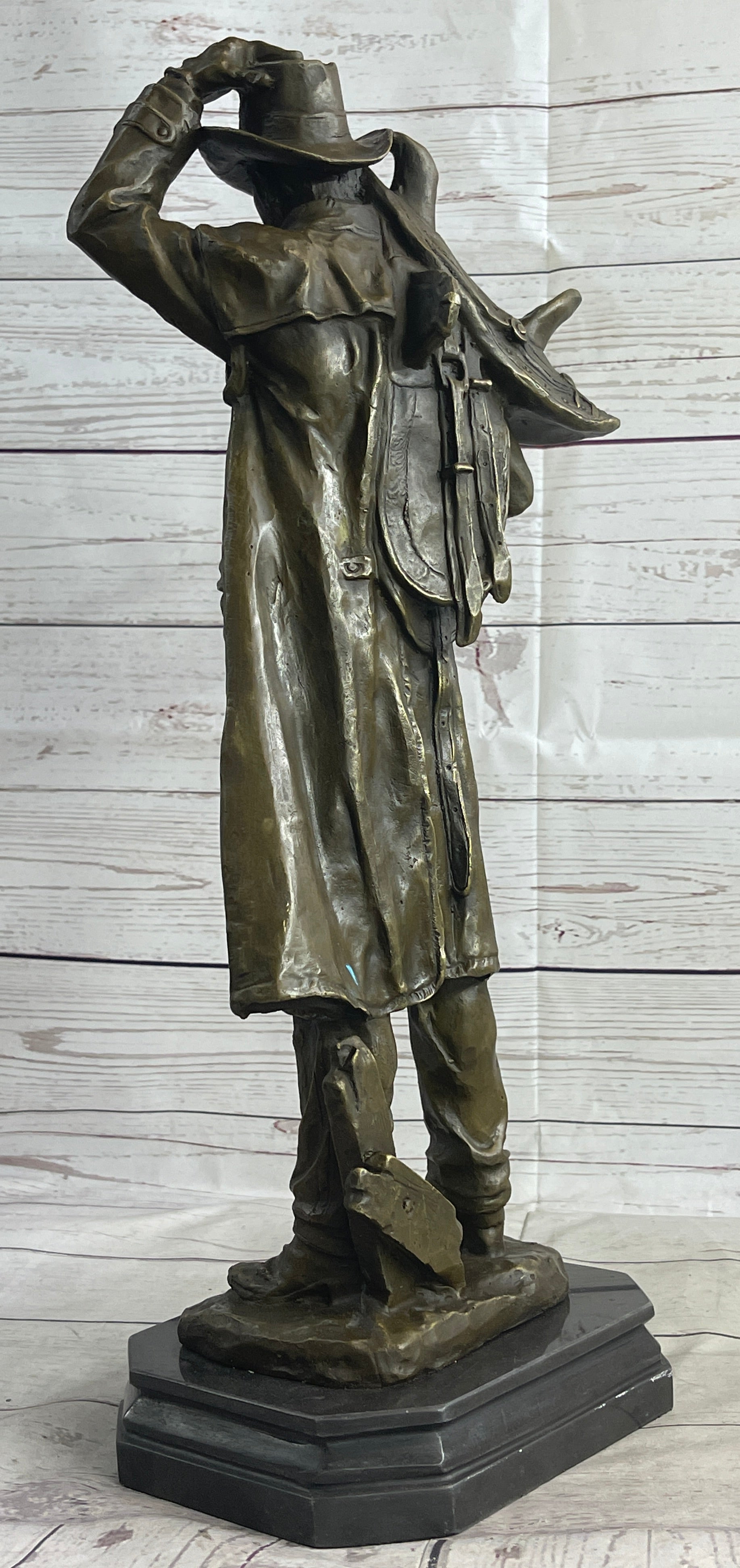 Country Western Cowboy Hauling Saddle Bronze Sculpture